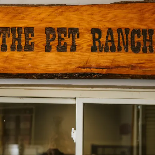 wooden sign that says "The Pet Ranch" in black text